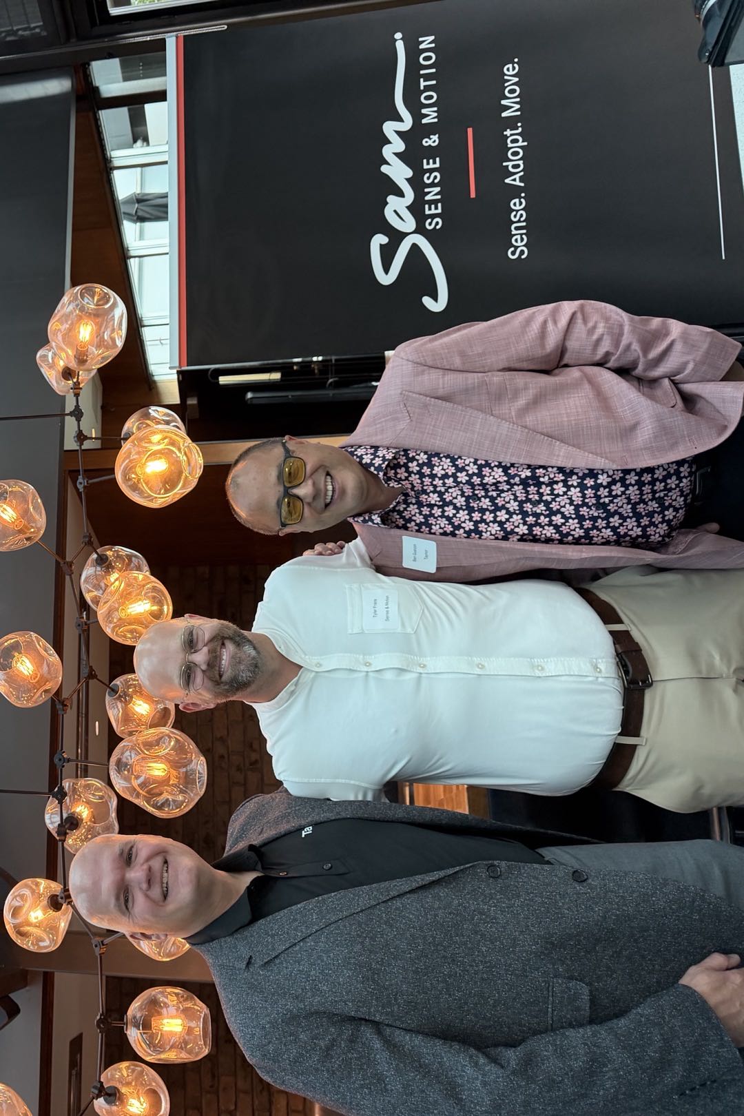 Andr&eacute; Lalande, Tyler Frans and Ben Guanzon standing together in front of the Sense and Motion banner at Joey&rsquo;s Burnaby