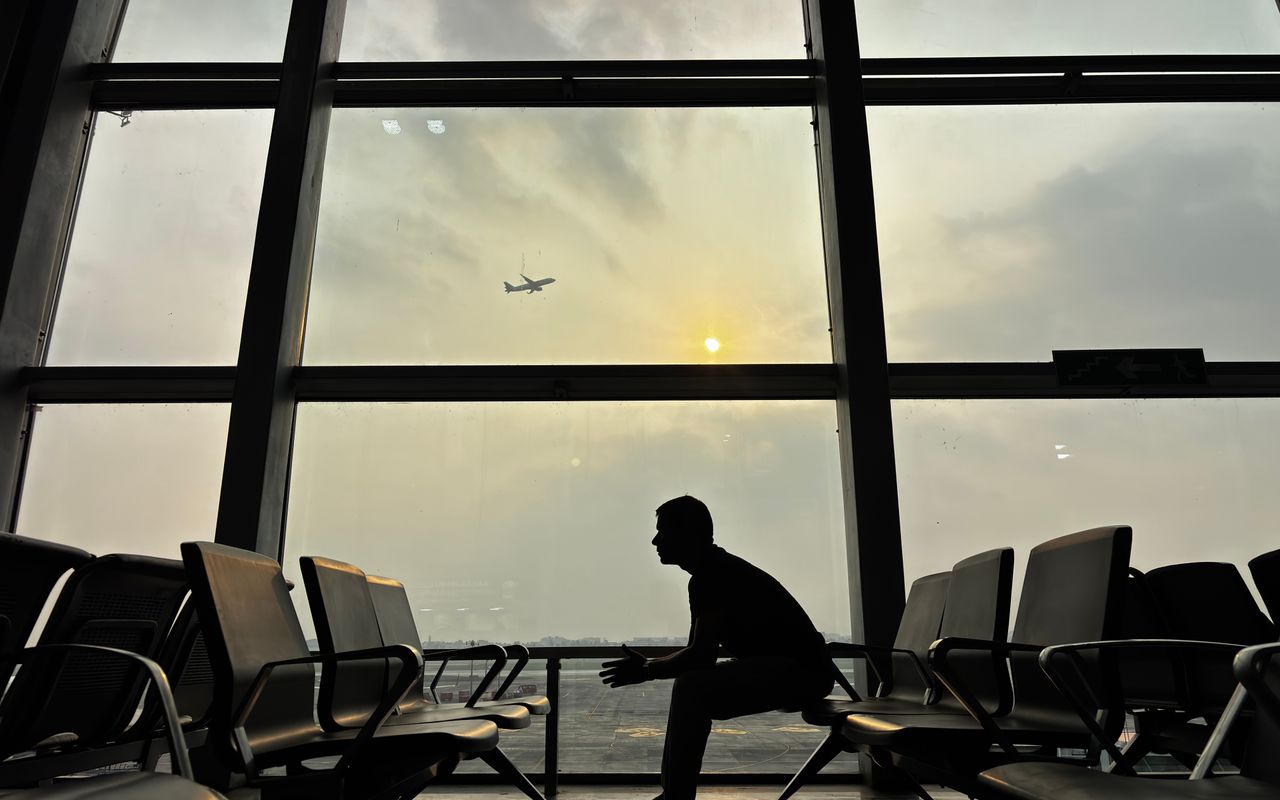 The silhouette of a traveller in an airport terminal