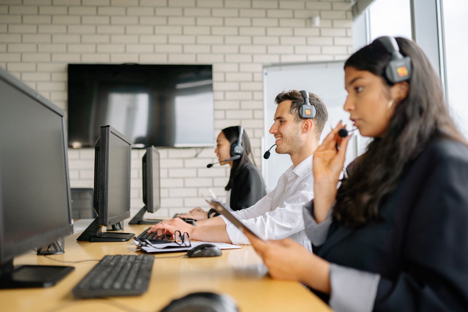 Call centre agents working at their computers with headsets