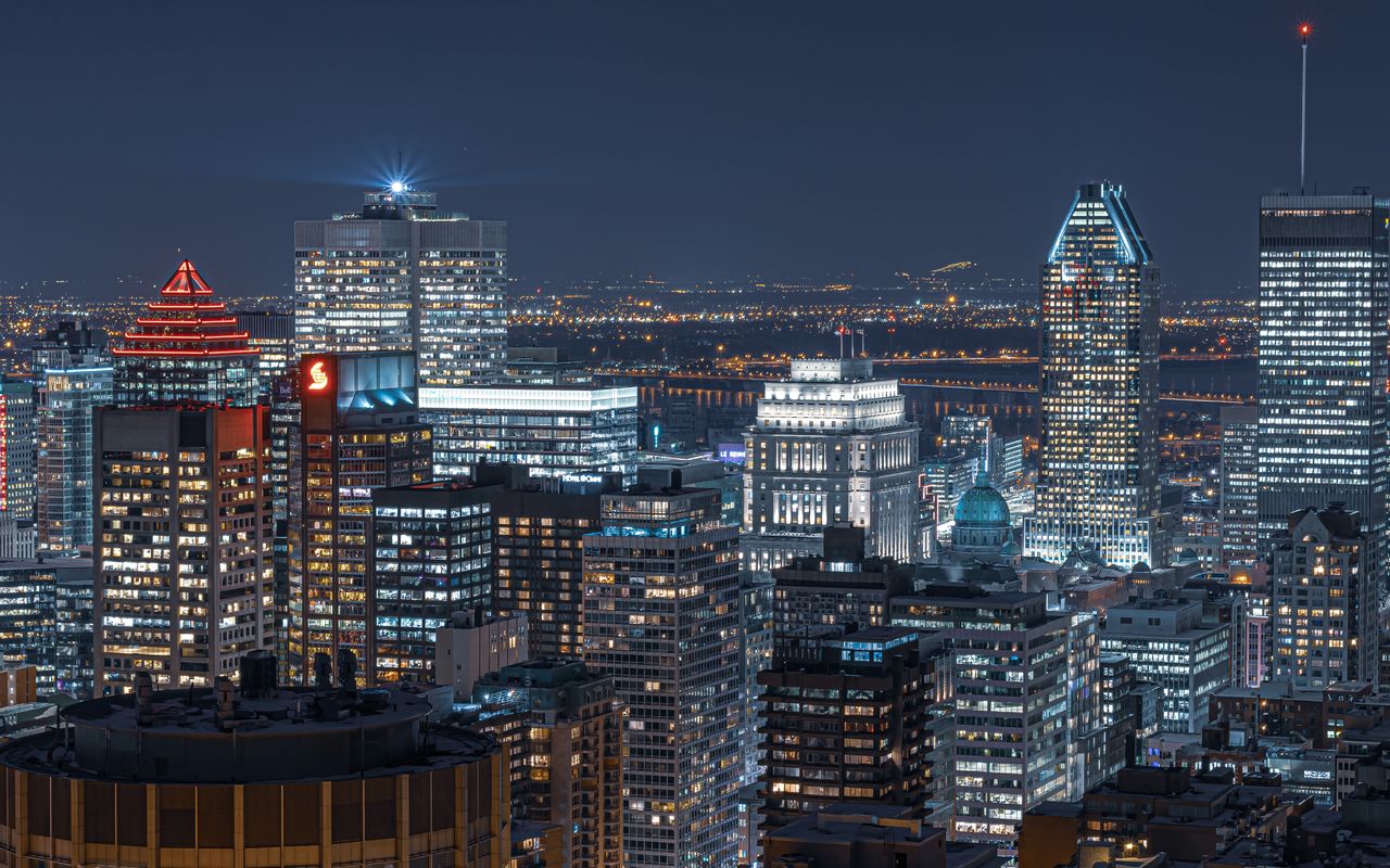 An aerial view of a Canadian downtown skyline lit up at night